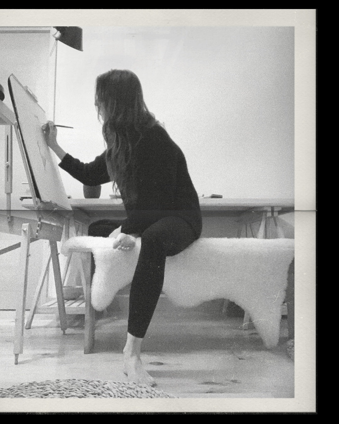 black and white photo of antonia reyes montealegre, wildlife artist from chile, drawing a bird